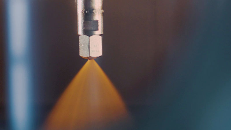 Spray drying nozzle dispersing coffee extract into fine droplets